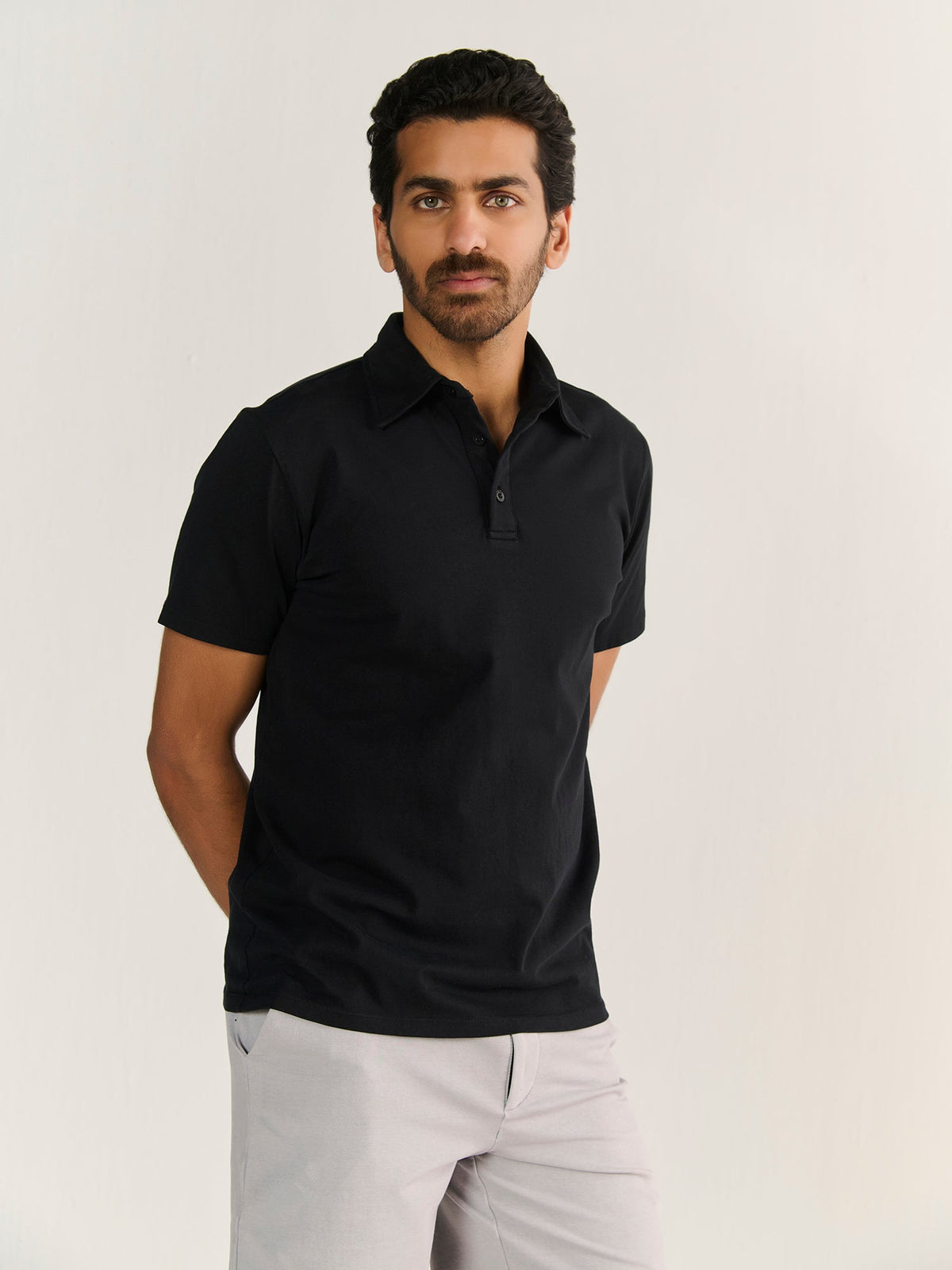 Heavy Short Sleeve Polo in Black, worn by a model