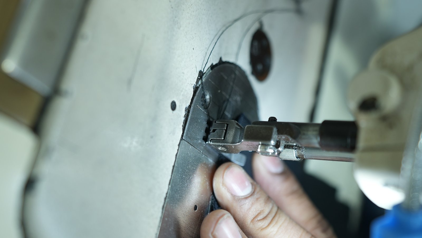 Sewing machine stitching black fabric