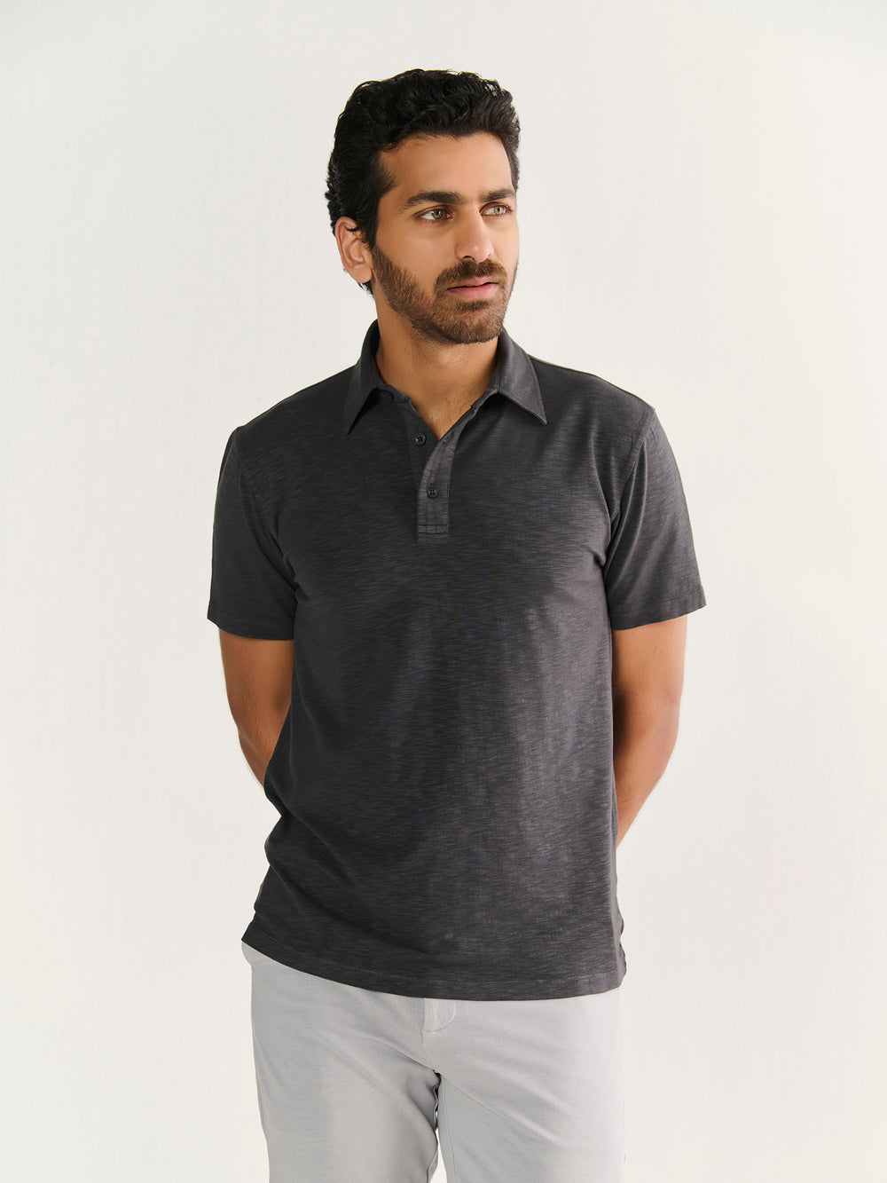 Textured Slub Short Sleeve Polo in Charcoal - front view on model