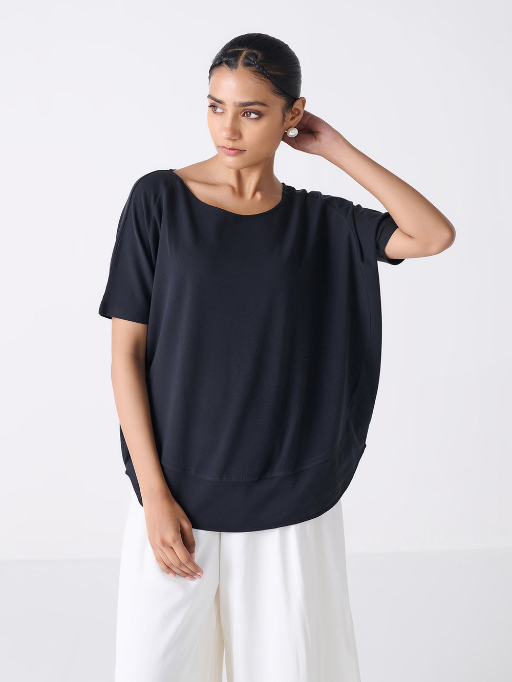 Flowy Fit Top in Black - front view on model