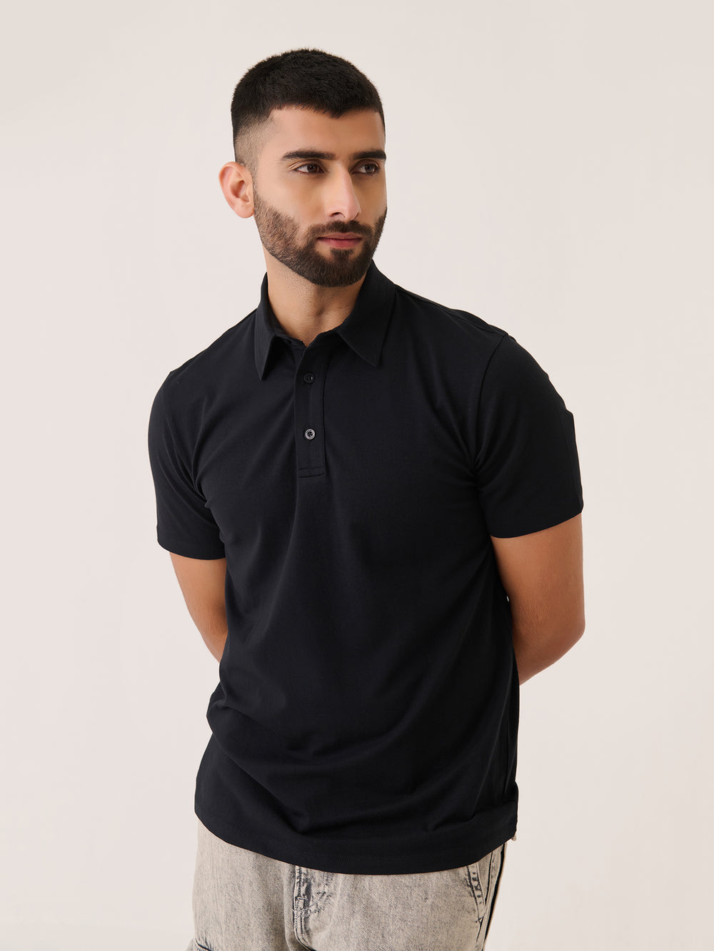 Short Sleeve Polo in Black - front view on model