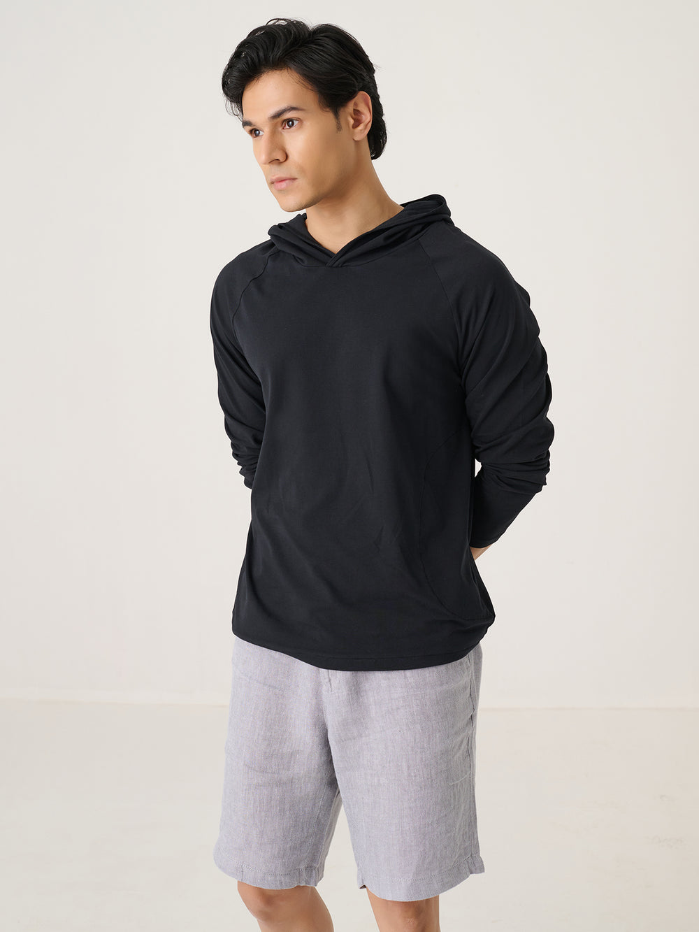 The Lightweight Hoodie in Black - front view on model
